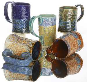mugs: Hand stamped, rolled, and glazed.